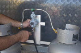 gas connection repairs on the front of a caravan